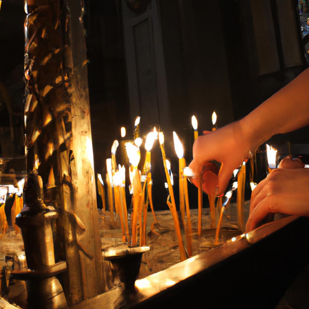 Person lighting candles in church