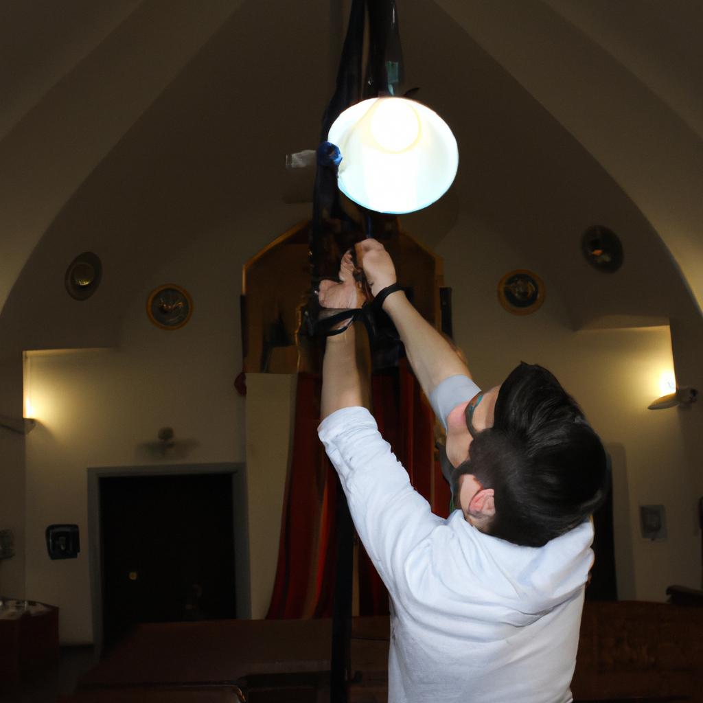 Person adjusting church sanctuary lighting