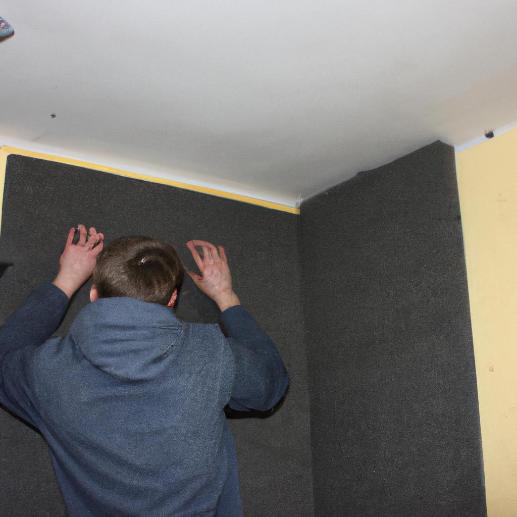 Person installing acoustic panels